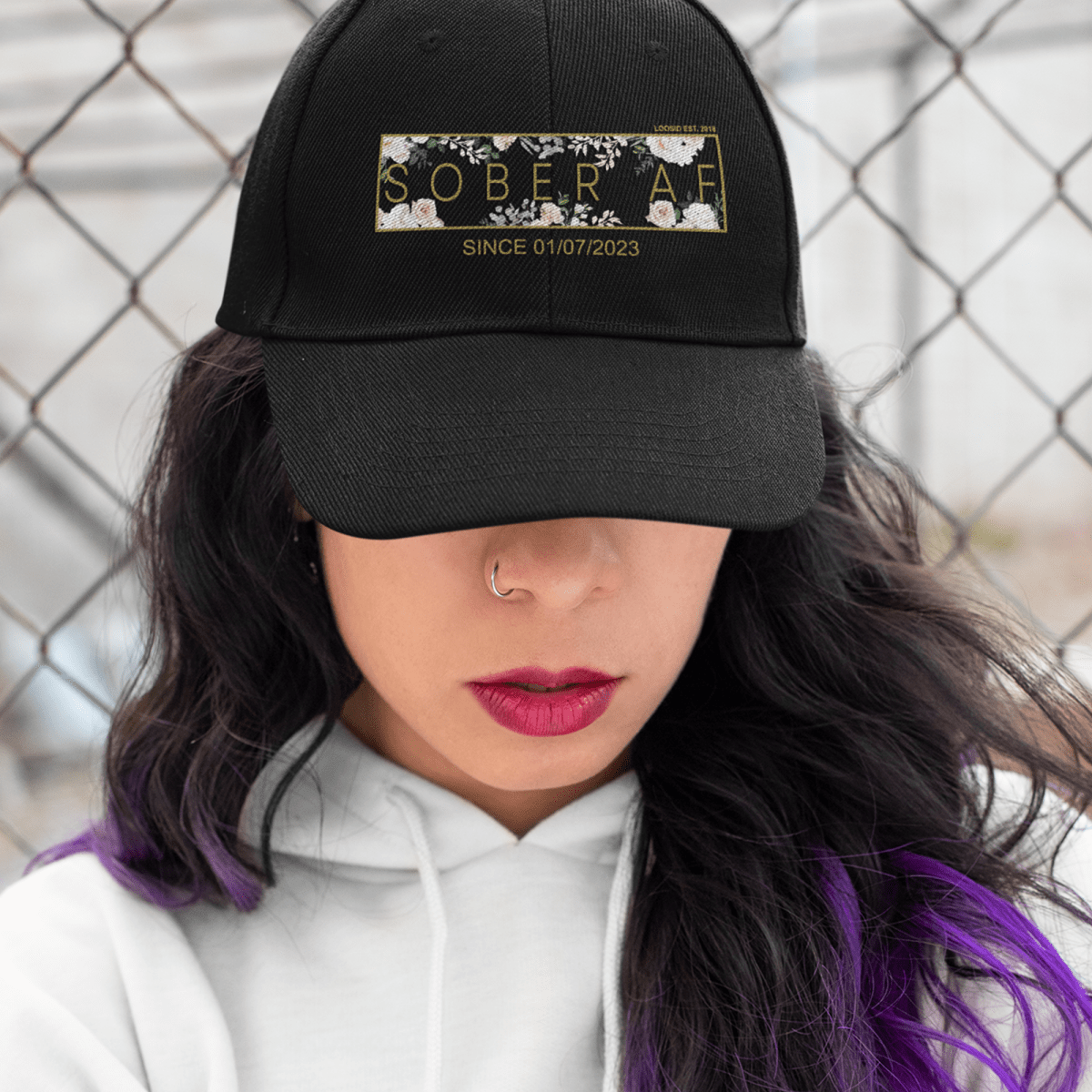 Woman wearing a custom embroidered Sobriety Hat outdoors