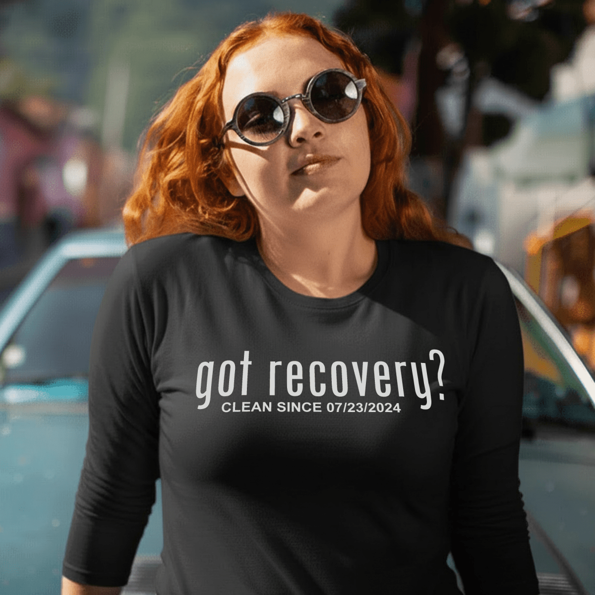 Person wearing a black t-shirt with 'got recovery?' text, standing outdoors.