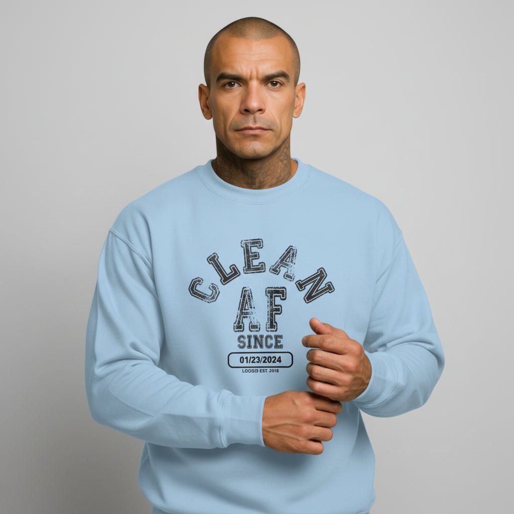 Flat lay of Loosid light blue sober merchandise crewneck highlighting Clean AF Since personalized date area β Loosid
