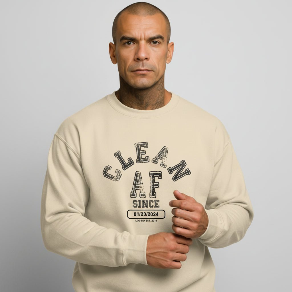 Flat lay of Loosid sand-toned Clean AF Since personalized sobriety gift crewneck sweatshirt β Loosid