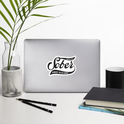 Loosid Sober Since personalized sobriety magnet displayed on a laptop in a styled desk workspace setting