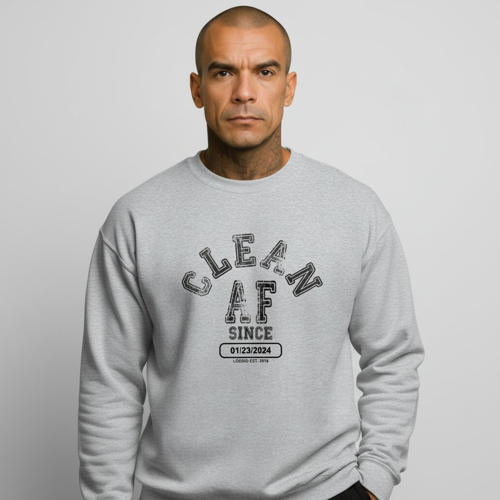 Flat lay of Loosid heather gray Clean AF Since personalized Recovery crewneck with sobriety date graphic — Loosid